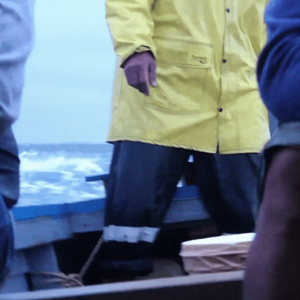 Three obscured figures ride in a boat over rough seas